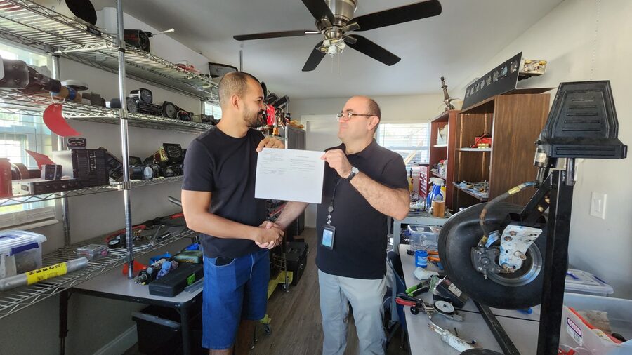 A&P student shaking hands with instructor after passing the practical test